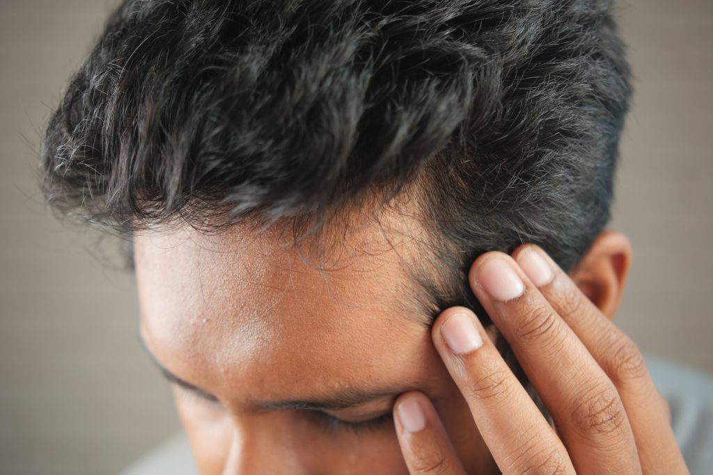 A man with slight hair loss wonders which treatment option is right for him.